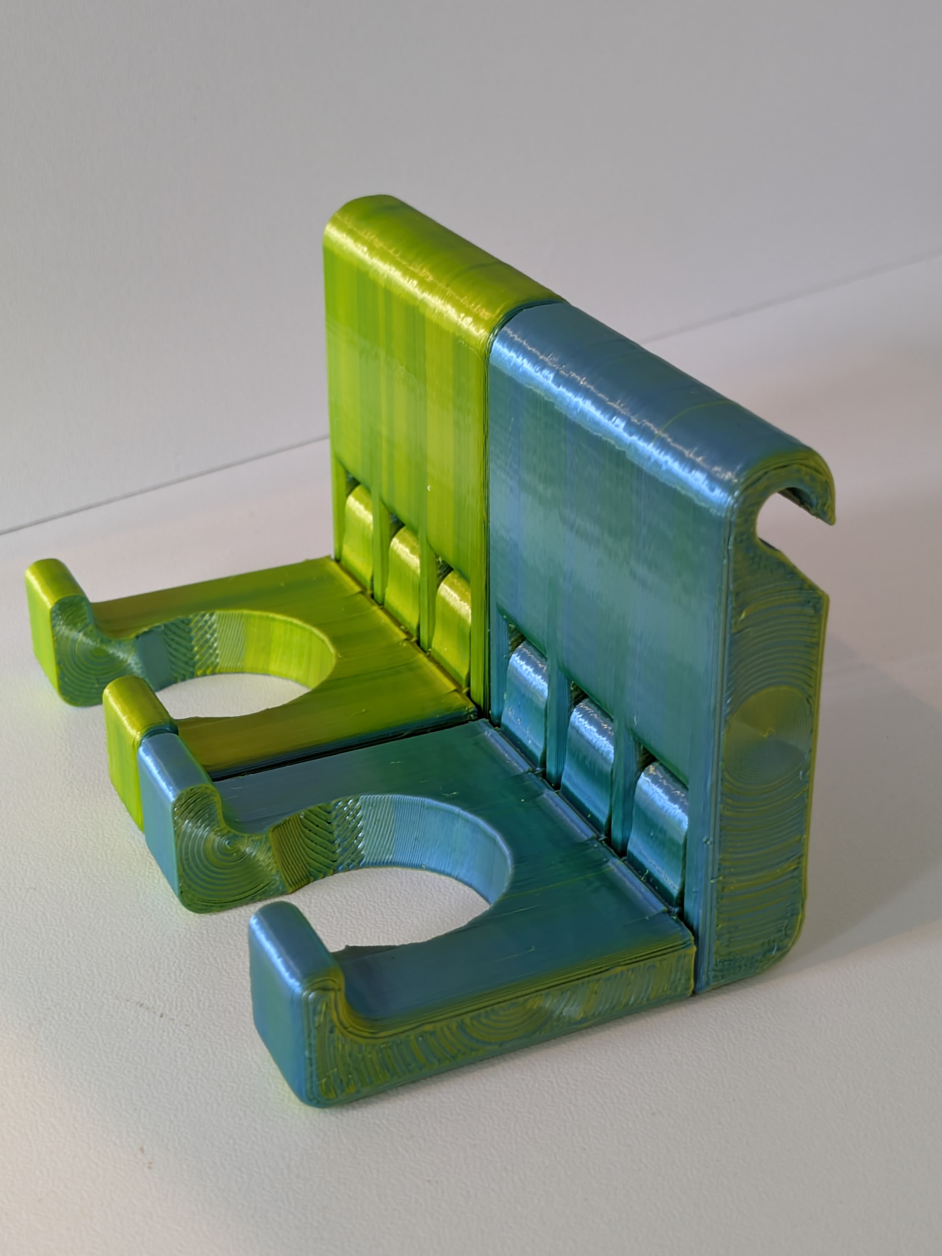 Green and teal BattyUp bat holders showing the colour range